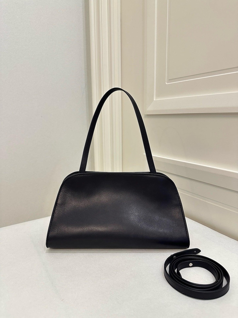 genuine leather handbag
smooth leather purse
soft structured leather
premium leather clutch
handmade leather bag
real leather shoulder bag
high quality leather purse
durable leather handbag
zipper closure handbag
detachable strap purse