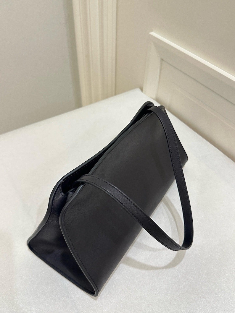 minimalist black leather bag
small luxury shoulder bag
premium black clutch purse
structured evening handbag
sleek leather top handle bag
compact designer style purse
modern black shoulder purse
elegant leather underarm bag
high end minimalist handbag
refined black leather purse
luxury small handbag women
minimal everyday leather bag
stylish black evening purse
designer look leather bag
fashion forward shoulder bag