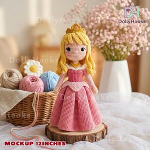 May include: A handmade crochet doll of a princess, approximately 12 inches tall, wearing a pink dress and a golden crown. The doll has blonde hair and is displayed on a wooden slice. The background includes yarn and flowers.