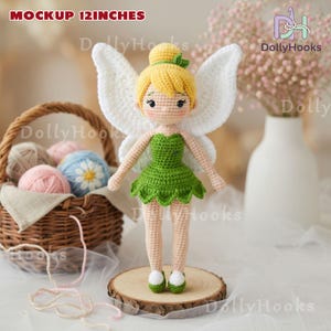 May include: A handmade crochet fairy doll, approximately 12 inches tall, with blonde hair, green dress, and white wings. The doll is standing on a wooden slice. The text "MOCKUP 12 INCHES" is visible in the image.