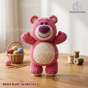May include: A handmade, pink crochet bear with a white belly and purple nose. The bear is approximately 16 inches tall. The bear has a smiling face and outstretched arms. The image also includes a basket of yarn and wooden spools.