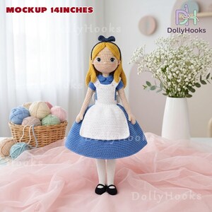 May include: A handmade crochet doll, 14 inches tall, dressed in a blue and white dress with a black bow. The doll has blonde hair and black shoes. The text "MOCKUP 14 INCHES" is visible at the top. The doll is a handmade item.