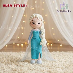 May include: A handmade crochet doll in the style of Elsa from Frozen. The doll has a light skin tone, white braided hair, and is wearing a turquoise dress with a slit. The doll is standing on a white rug. The text "ELSA STYLE 1 Hooks" is visible.