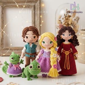 May include: A collection of handmade crochet dolls, including a princess with long yellow hair, a prince, and a woman in a red dress. Two green chameleons are also featured. The dolls are set against a soft, neutral background.