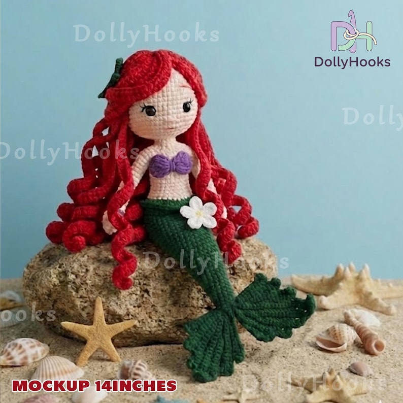 May include: A handmade crochet mermaid doll with red hair, a purple top, and a green tail. The doll is approximately 14 inches tall and is sitting on a rock with seashells and a starfish.