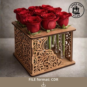 May include: A wooden laser-cut flower vase with a decorative openwork design, holding nine red roses. The vase has individual glass tubes for each flower. The image includes the text "LASER CUT FILES" and "FILE format: CDR".