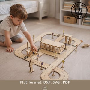 Può includere: Un bambino gioca con un set di strade giocattolo in legno. Il set include pezzi di strada, edifici e segnali stradali. I pezzi della strada sono marrone chiaro con strisce nere. Il testo "FILE format: DXF, SVG, PDF" è in basso.