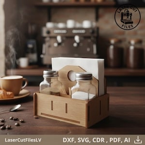 May include: Wooden condiment and napkin holder with two glass jars and a napkin slot. The jars have silver lids and contain salt and pepper. The holder is on a wooden table with coffee and a croissant. The image includes the text "LaserCutFilesLV".