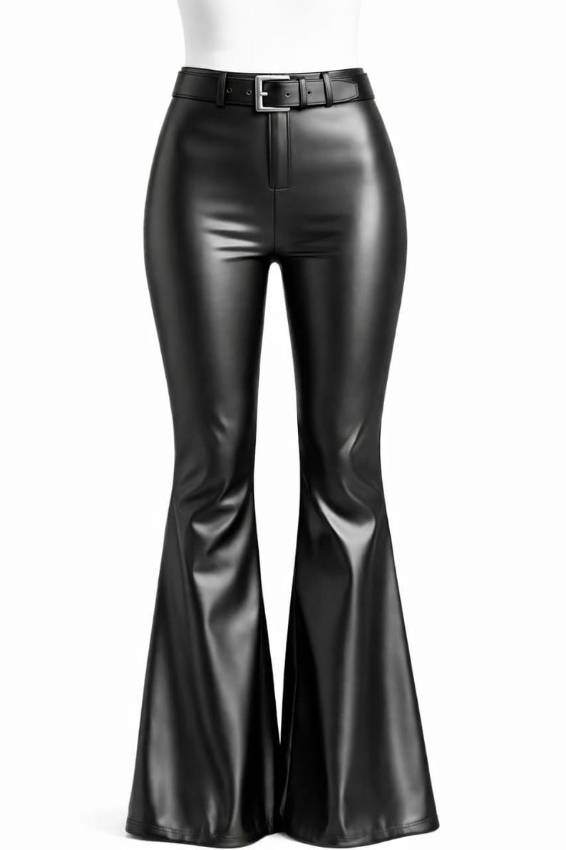 May include: Black faux leather flared pants with a high waist and a belt. The pants have a fitted silhouette through the hips and thighs, and flare out from the knees. The belt has a silver buckle.