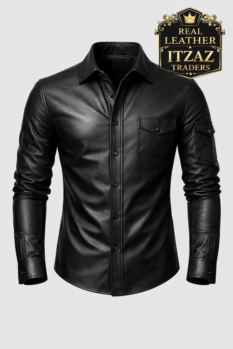 Op de afbeelding: Zwart leren overhemd met kraag, manchetten met knopen en twee borstzakken. Het overhemd heeft ook twee mouwzakken. Het logo "REAL LEATHER ITZAZ TRADERS" staat rechtsboven.