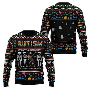 May include: A black long-sleeve sweater featuring a colorful puzzle piece pattern, snowflakes, and Christmas trees. The front displays the text "AUTISM IT'S NOT A DISABILITY IT'S A DIFFERENT ABILITY" with four skeletons, one of which is dabbing.