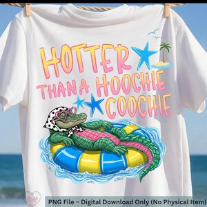 May include: White t-shirt with the phrase "HOTTER THAN A HOOCHIE COOCHIE" in pink and yellow lettering. The shirt features a cartoon alligator wearing glasses and a scarf, floating on an inner tube. Blue stars and a palm tree are also included in the design.