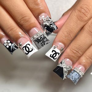 May include: A set of three ceramic mugs with a speckled, matte finish. The mugs are in shades of cream, light gray, and dark gray. Each mug has a simple, modern design and a rounded handle.