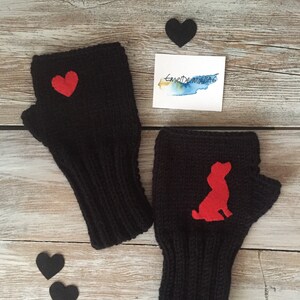 May include: A pair of black fingerless gloves with red felt accents. One glove has a heart shape and the other has a dog silhouette.