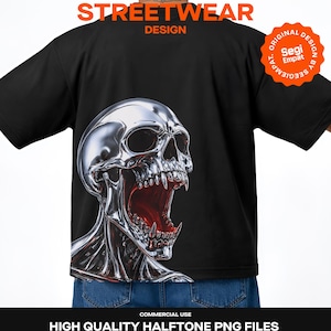May include: A black t-shirt featuring a large, metallic chrome skull graphic with an open mouth and sharp teeth. The design includes orange text that reads Y2K STREETWEAR DESIGN and a circular orange badge with the text ORIGINAL DESIGN BY SEGI EMPAT.