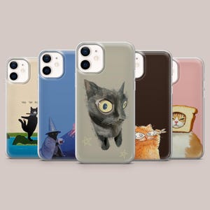 May include: Five phone cases with quirky cat designs. The cases showcase illustrations of cats in various scenarios: a cat with text, a wizard cat, a black cat portrait, an orange cat with a fish, and a cat with bread. Each case has a transparent edge.