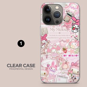 May include: Clear phone case with a fragmented design featuring My Melody characters, strawberries, and text. The case is predominantly pink and white, with a collage-like aesthetic.