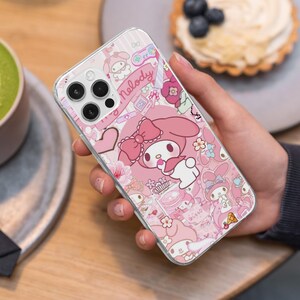 May include: Clear phone case with a pink My Melody design. The case features a repeating pattern of My Melody characters, bows, hearts, and flowers. The word "Melody" is written in pink script. The case is held in a hand.