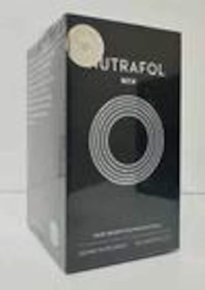 May include: A black box with the word "NUTRAFOL" in white text and a circular design. The box also includes the text "HAIR WELLNESS SUPPLEMENT" and other text. The box is sealed in clear plastic.