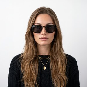 May include: Square-framed sunglasses with black lenses and thin black frames. The eyewear features a bridge and slim temples, providing a classic look. The dark lenses offer full coverage, while the frame design maintains a clean, structured appearance.