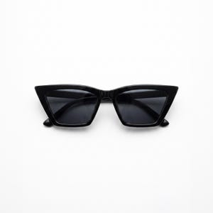 May include: Black cat-eye sunglasses featuring a glossy plastic frame and dark tinted lenses. The eyewear has a sharp, angular silhouette with pointed outer corners and a bridge connecting the two lenses, providing a sleek and uniform appearance.