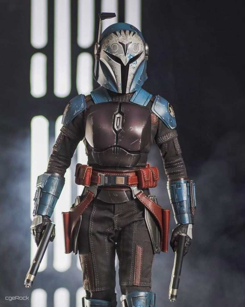 May include: A detailed action figure of a character in a blue and silver helmet and armor, holding two blasters. The figure has a red belt with pouches and is posed against a dark background.
