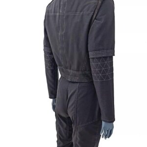 May include: A set of three ceramic mugs with a speckled, matte finish. The mugs are in shades of cream, light gray, and dark gray. Each mug has a simple, minimalist design and a rounded handle.