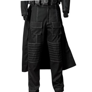 May include: Black tactical pants with white stitching and multiple pockets. The pants have reinforced knee panels with horizontal stitching. A black coat is visible in the background.