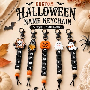 May include: Five custom Halloween keychains with black lobster clasps, featuring silicone charms of a spider web, gnome, pumpkin, ghost, and ghost with hat. Each keychain has black letter beads spelling DEMI, RUBY, CUSTOM, BILLY, and NAME.