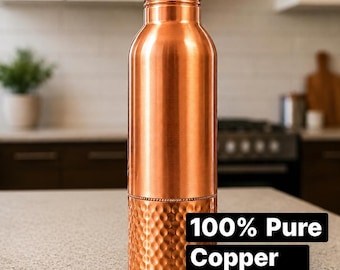 May include: A cylindrical water bottle made of polished copper with a smooth upper section and a hammered texture on the lower half. The bottle features a matching screw-top lid and includes text that reads 100% Pure Copper.