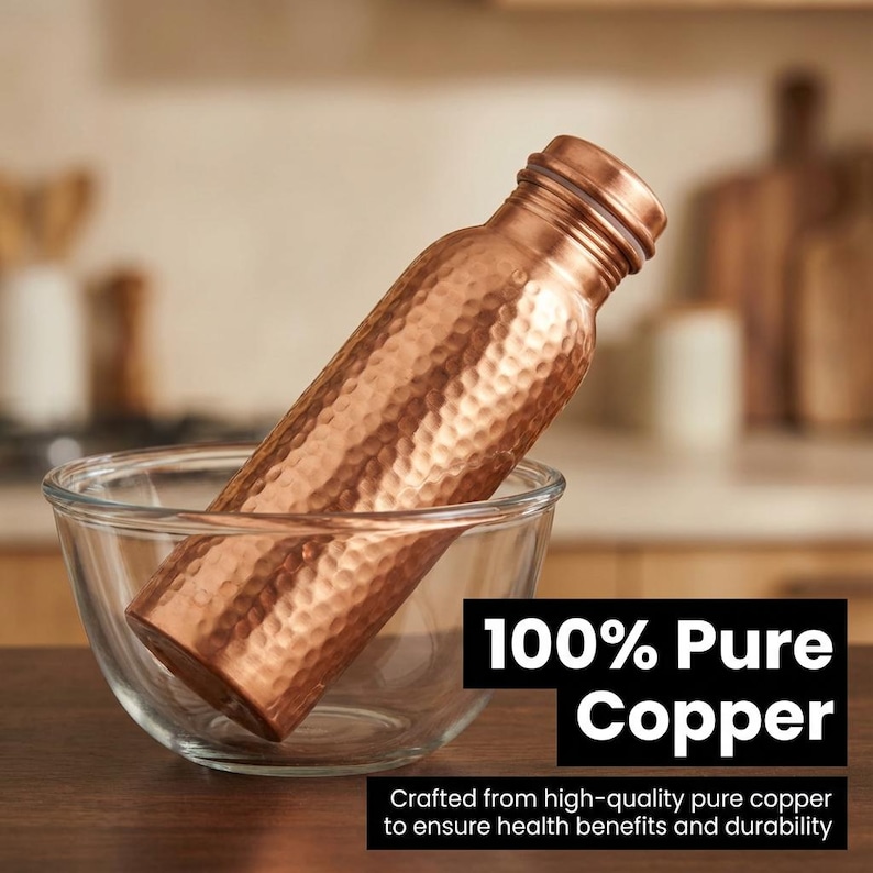 May include: A hammered copper water bottle with a metallic finish, resting inside a clear glass bowl. The bottle features a cylindrical body and a screw-top lid. Text on the image reads 100% Pure Copper and Crafted from high-quality pure copper.