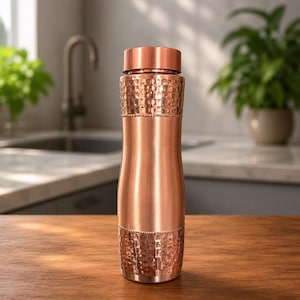 May include: A cylindrical copper water bottle featuring a smooth central section flanked by hammered textured bands at the top and bottom. The bottle has a matching flat copper cap and a polished metallic finish that reflects light across its surface.