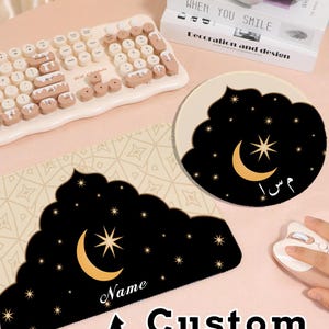 May include: A custom name mousepad and coaster set featuring a black night sky design with a crescent moon and stars. The mousepad has the word "Name" and the text "Custom name". A cream-colored keyboard is also visible.