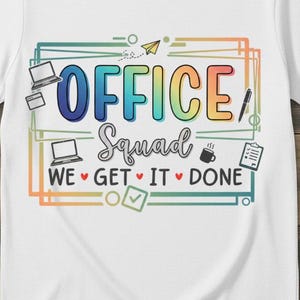 May include: White t-shirt with the words "OFFICE Squad" in a colorful design. The shirt includes graphics of a laptop, coffee cup, pen, and checklist, with the phrase "WE GET IT DONE".