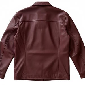 May include: A burgundy leather jacket with a collared neckline and buttoned cuffs. The back view of the jacket shows vertical seams and a tailored fit. The jacket has a classic, timeless design.