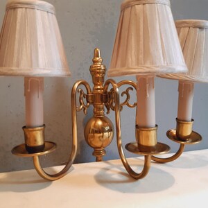 vägglampa med 3 ljuslampor, mässing med 3 tygskärmar.