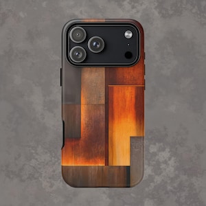 Può includere: Custodia per smartphone con un design geometrico nei toni del marrone, arancione e grigio. La custodia ha un bordo nero e un modulo fotocamera con tre obiettivi.