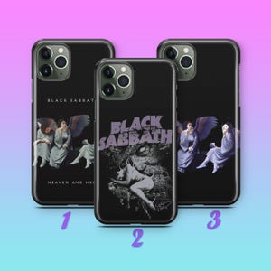 May include: Three black smartphone cases featuring Black Sabbath artwork. Case 1 displays the Heaven and Hell album cover. Case 2 shows a goat-like figure with the text Black Sabbath. Case 3 depicts winged figures. Each case has a triple camera cutout.
