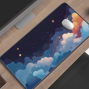 May include: A rectangular desk mat featuring a dark night sky filled with scattered stars and large, soft clouds in shades of deep blue, light blue, and warm orange. The mat has a smooth surface and a black border, providing a wide area for a mouse.