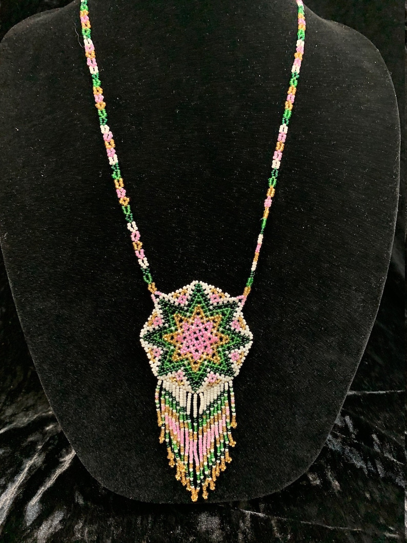 Huichol Beaded Pendant with traditional star design in pinkgreengold