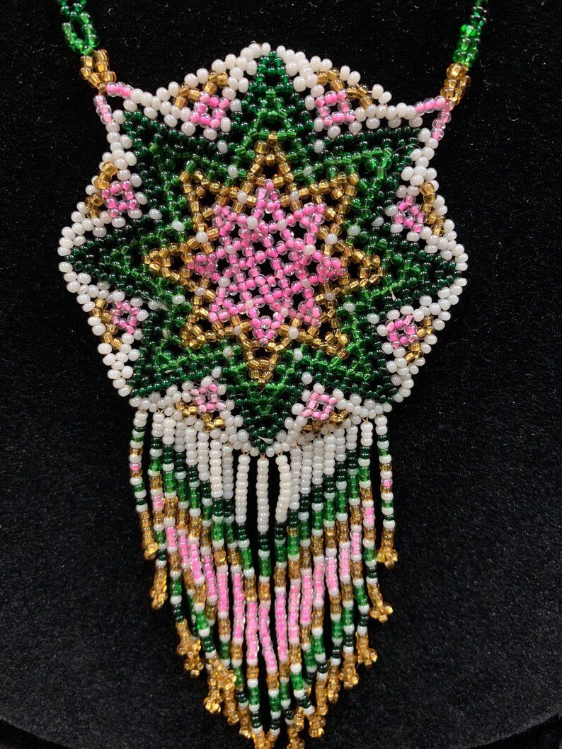 Huichol Beaded Pendant with traditional star design in pinkgreengold