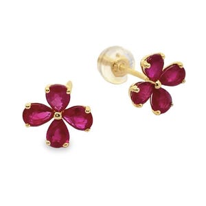 May include: A pair of gold-colored stud earrings, each featuring a four-petal flower design. The petals are a vibrant red, and the earrings are set against a white background. The earrings are designed to be worn in pierced ears.