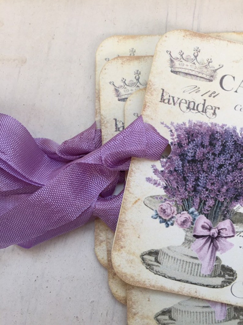 May include: Set of vintage-style gift tags with a lavender theme. Each tag features a crown, the text "No. 1 Lavender", and a bouquet of lavender in a hat.