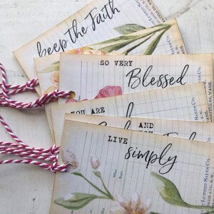 May include: Four vintage-style gift tags with floral illustrations and handwritten text. The tags feature the phrases "beep the Faith", "SO VERY Blessed", "YOU ARE", and "LIVE simply".