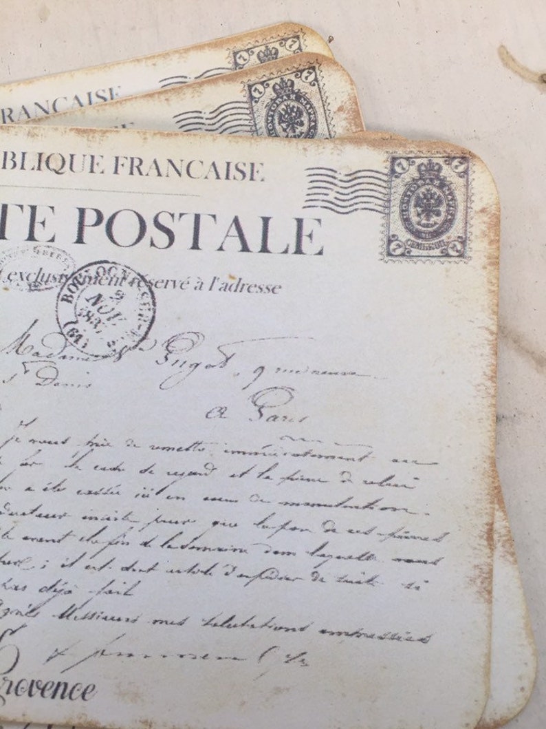 May include: A vintage postcard with a faded, handwritten message in French. The postcard features a stamp with the words "Republique Francaise" and "La Poste".
