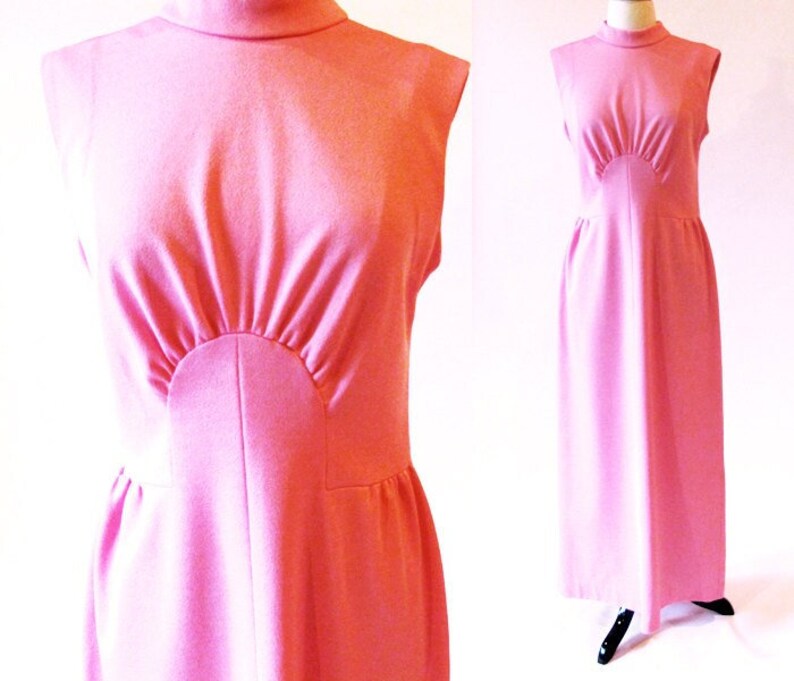 May include: A sleeveless pink maxi dress with a high mock neck and a fitted bodice. The dress has a unique design with a curved panel at the bust.