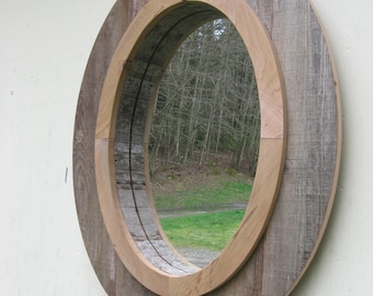 wood oval wall mirror with decorative compass point