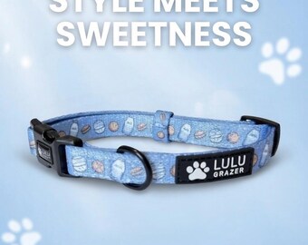 May include: A light blue dog collar with a pattern of white and tan food-themed illustrations. The collar has a black buckle and a black D-ring. The text "STYLE MEETS SWEETNESS" is at the top. The brand name "LULU GRAZER" is on a black patch.