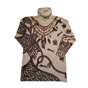 May include: A light grey turtleneck sweater with long sleeves. The sweater features a leopard print pattern on the sleeves and lower body, with a decorative necklace design and running animal figures. The design incorporates brown, tan, and orange tones.