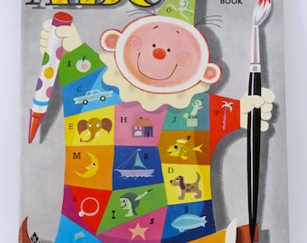 May include: Vintage ABC coloring book cover featuring a whimsical clown holding a paintbrush and a pen. The clown's outfit is a patchwork of colorful squares with letters and illustrations. The cover has the text "ABC" and "COLORING BOOK".